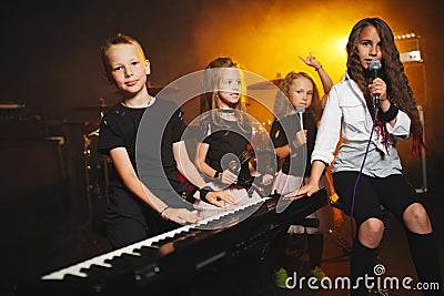 Children singing and playing music in recording studio Stock Photo