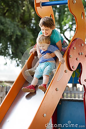 Happy children on slide Stock Photo