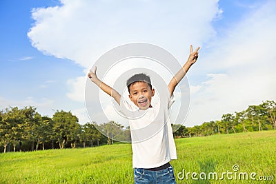 Happy children standing on meadow and raise hands Stock Photo