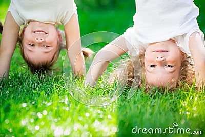 Happy children standing upside down Stock Photo