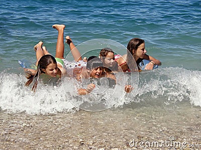 Happy childrens enjoy on waves Stock Photo