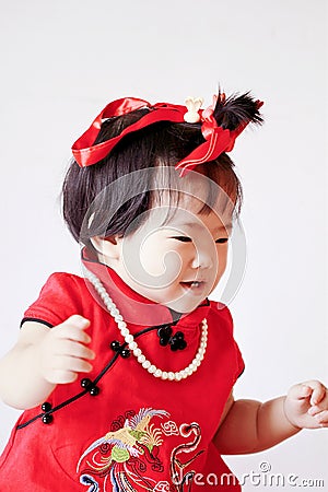 Happy Chinese little baby in red cheongsam have fun Stock Photo