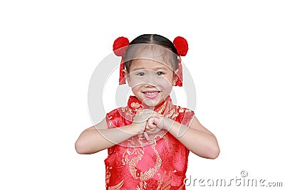 Happy chinese new year. Little Asian girl with Congratulation gesture isolated on white background Stock Photo