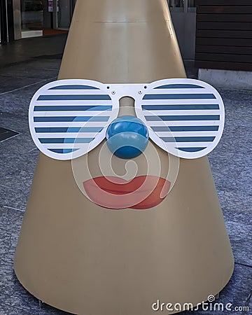 Happy christmas cone face wearing sunglasses in a city mall Editorial Stock Photo