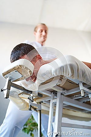 Client smiling in massage cabinet on a table Stock Photo