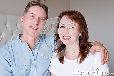 Happy closeup people faces. Smiling middle age couple at home. Family fun time weekend and strong love relationship. Healthy smile Stock Photo