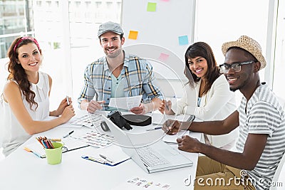 Happy colleagues sitting and looking at camera Stock Photo
