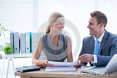Happy colleagues working together on laptop and folder Stock Photo