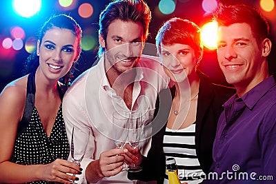 Happy companionship in discotheque Stock Photo