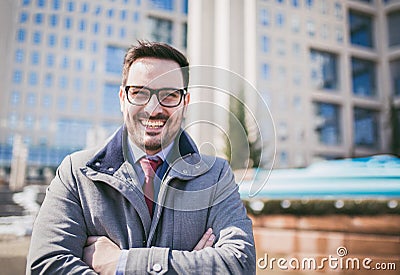 Happy company leader CEO boss executive standing in front of building Stock Photo