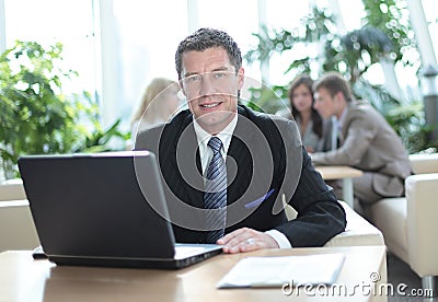 Happy middle age businessman looking at camera and smiling. Stock Photo