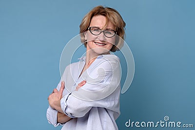 Happy confident old senior woman smiling with her ams crossed Stock Photo