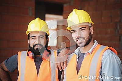 Happy Construction Workers Smiling At Camera In New Building Stock Photo