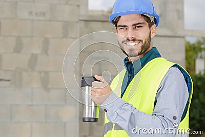 happy constructor holding coffee cup Stock Photo