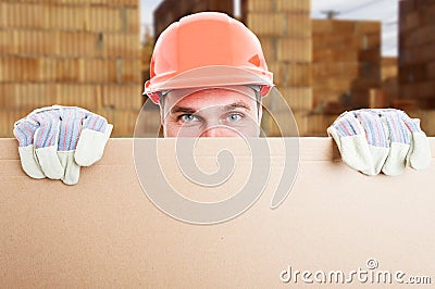 Happy constructor standing behind cardboard Stock Photo