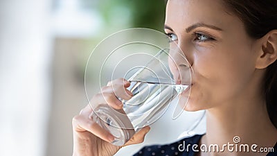Happy consumer girl drinking clean pure water from transparent glass Stock Photo