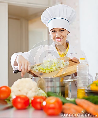 Happy cook woman cooking vegetarian dinner Stock Photo