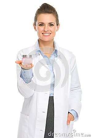 Happy cosmetologist woman showing creme Stock Photo