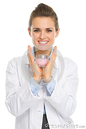 Happy cosmetologist woman showing creme Stock Photo