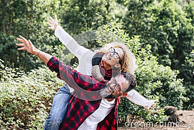 Happy couple of adult people caucasian man and woman have fun together in. outdor leisure activity in the nature- environment and Stock Photo