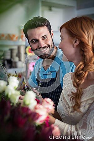 Happy couple arranging flowers Stock Photo