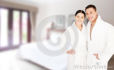 Happy couple in bathrobes over spa hotel room Stock Photo