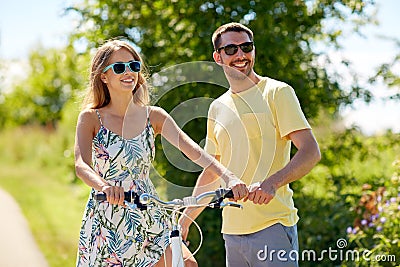 Happy couple with bicycle at country Stock Photo