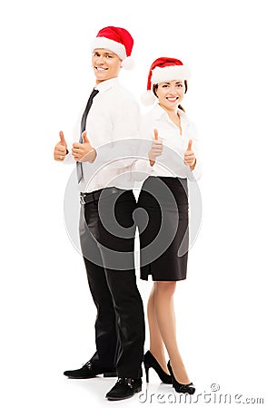 Happy couple of business persons in Christmas hats Stock Photo