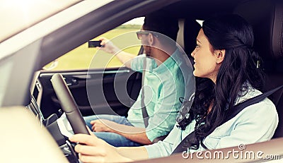 Happy couple in car taking selfie with smartphone Stock Photo