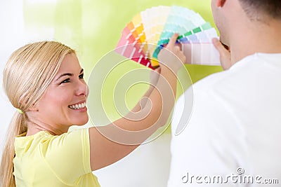 Happy couple choosing colors for painting Stock Photo