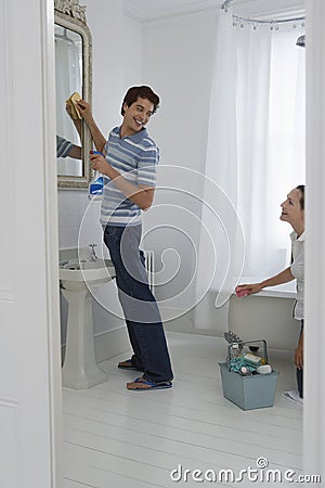 Happy Couple Cleaning Bathroom Stock Photo