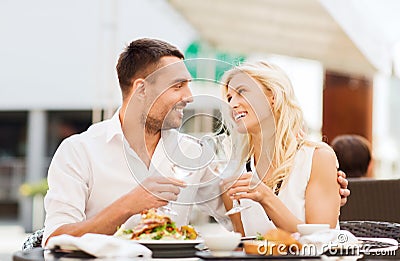 Happy couple clinking glasses at restaurant lounge Stock Photo
