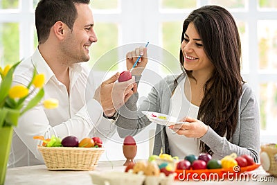 Happy couple coloring Easter eggs Stock Photo