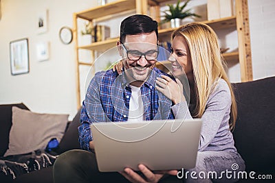 Couple communicating while using laptop at home Stock Photo
