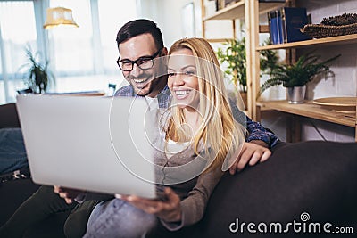 Couple communicating while using laptop at home Stock Photo