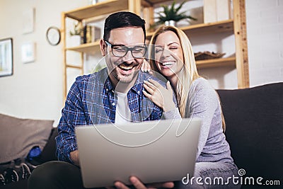 Couple communicating while using laptop at home Stock Photo