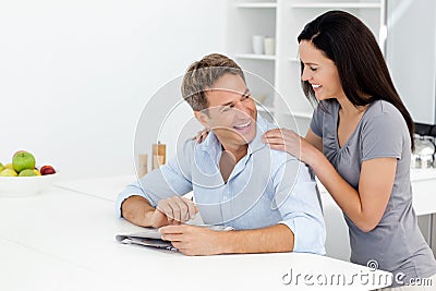 Happy couple doing a cryptic crossword together Stock Photo