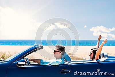 Happy couple driving convertible. Stock Photo