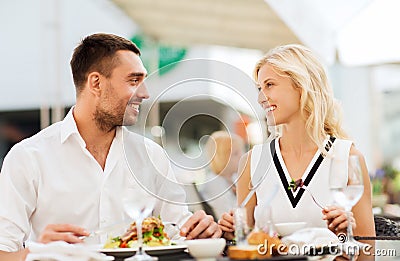 Happy couple eating dinner at restaurant terrace Stock Photo