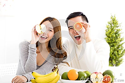 Happy couple eating fruit and healthy food Stock Photo