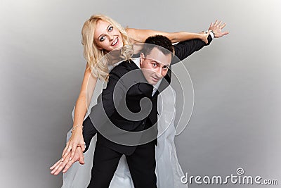 Happy couple enjoying flying, female on mans back Stock Photo