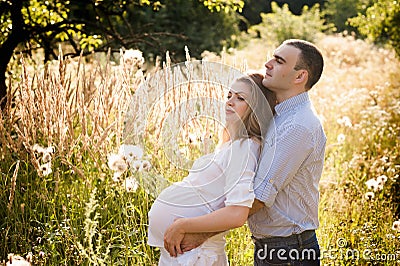 Happy couple future parents relaxing on nature, happy family, pregnancy Stock Photo