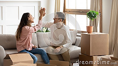 Happy couple give high five celebrate moving into new home Stock Photo