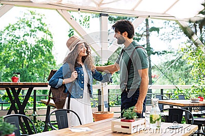 Happy couple greeting outdoors on terrace restaurant, end of lockdown. Stock Photo
