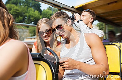 Happy couple with guidebook traveling by tour bus Stock Photo