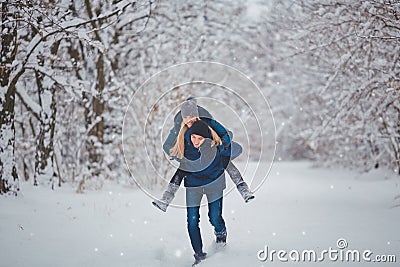 Happy Couple Having Fun Outdoors in Snow Park. Winter Vacation Stock Photo