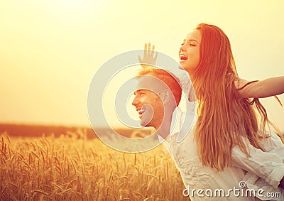 Happy couple having fun outdoors on wheat field Stock Photo