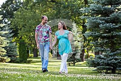 Happy couple, having joined hands walk in park Stock Photo