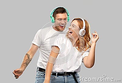 Happy couple in headphones dancing Stock Photo