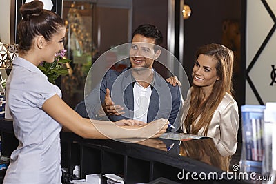 Happy couple at hotel reception Stock Photo